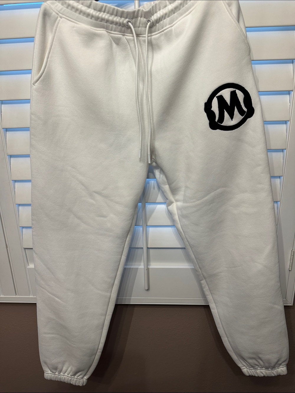 White Sweatpants with Black 'M' Logo